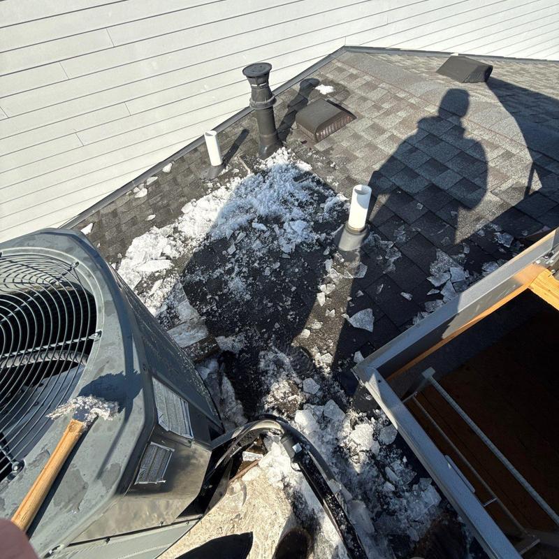 Shingle roof with hail damage near HVAC unit
