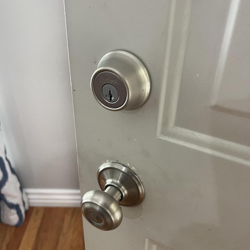 Deadbolt lock and door knob on white door