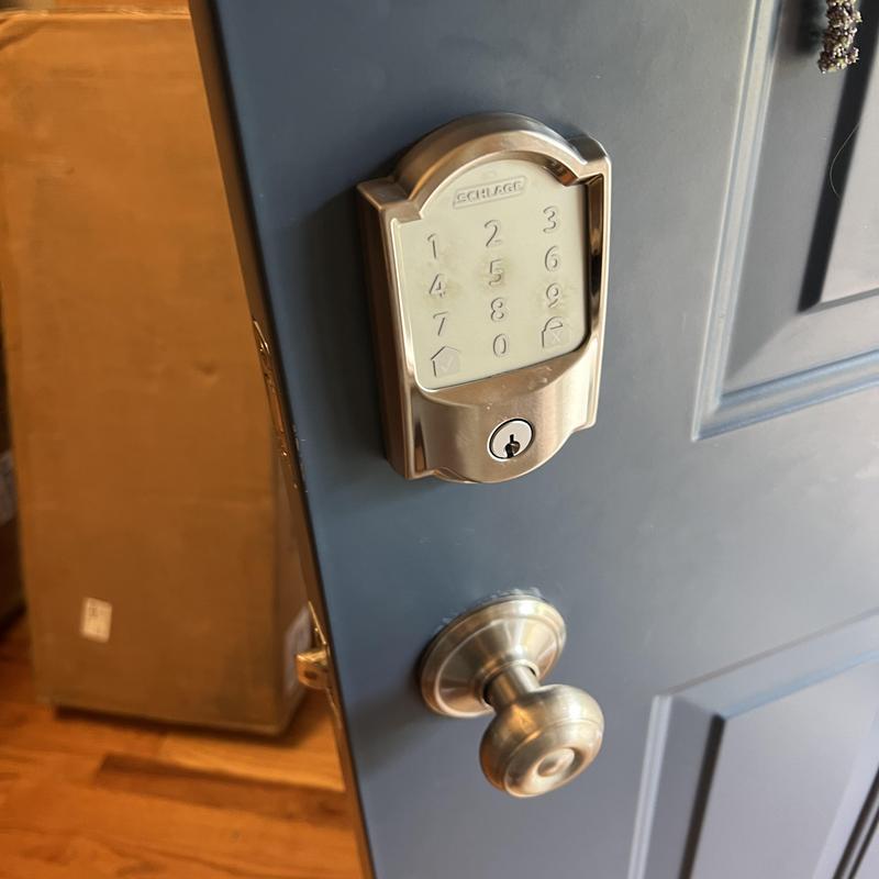 Keypad deadbolt lock on blue door with doorknob