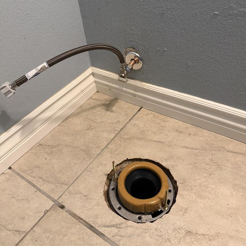Toilet flange replacement with wax ring on tiled floor