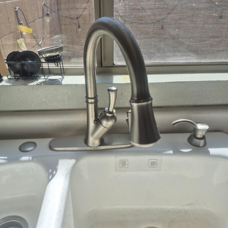 Kitchen faucet with soap dispenser and window background