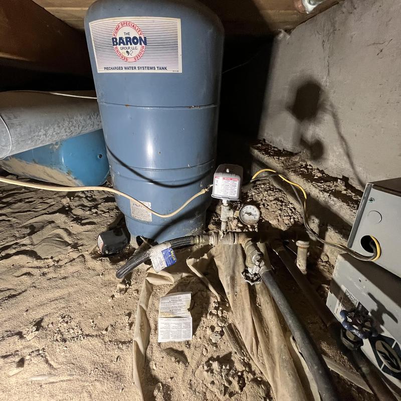 Pressure tank and irrigation piping in crawlspace Pressure tank and irrigation piping in crawlspace