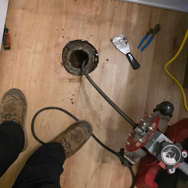 Toilet drain cable machine clearing clog