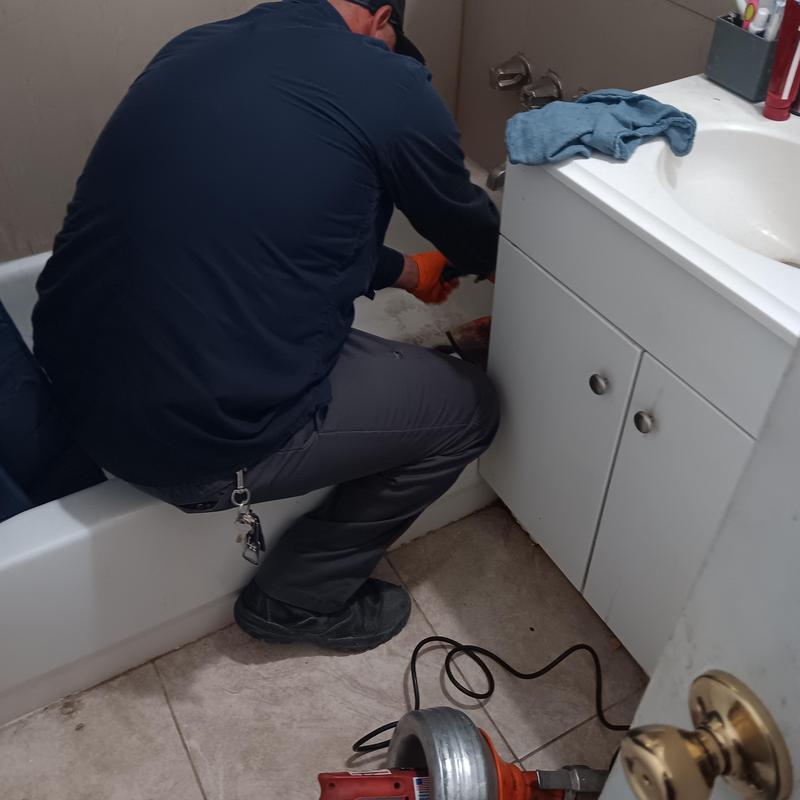 Bathtub drain plumbing snaking in bathroom repair