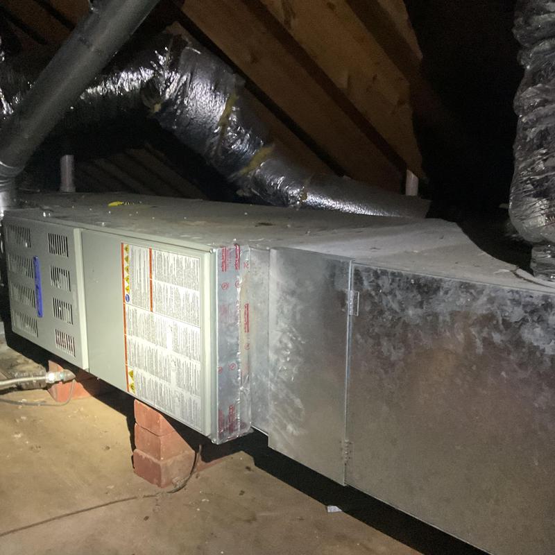 Furnace unit in attic with ductwork and insulation