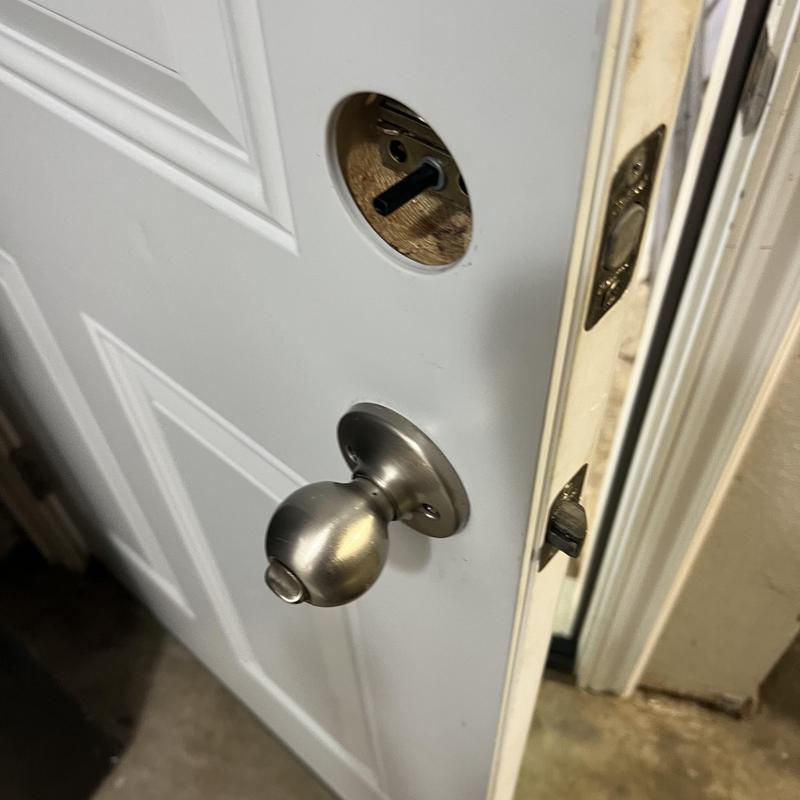 Double deadbolt lock hole on white door installation