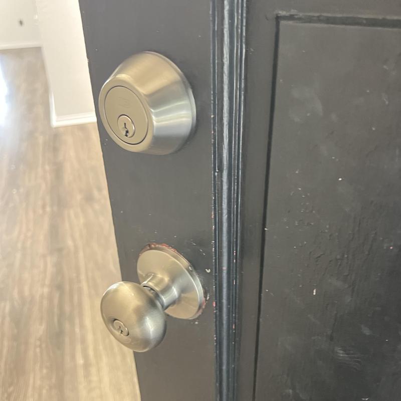 Double deadbolt lock and door knob on black door