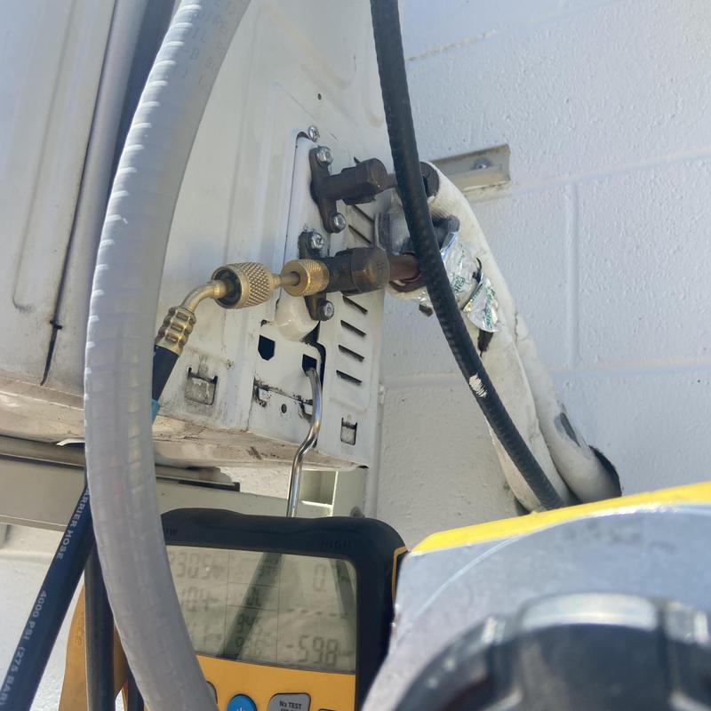 Service valve on HVAC unit with refrigerant gauge attached Service valve on HVAC unit with refrigerant gauge attached