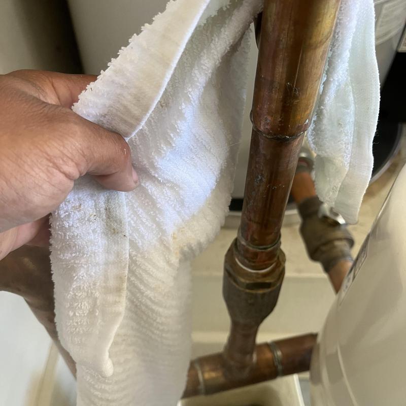 Radiant copper pipe section with hand and cloth Radiant copper pipe section with hand and cloth