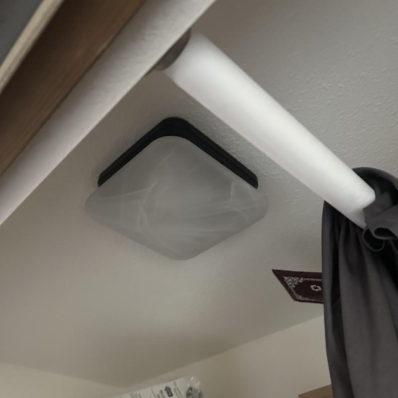 Ceiling light fixture with black trim near curtain rod Ceiling light fixture with black trim near curtain rod