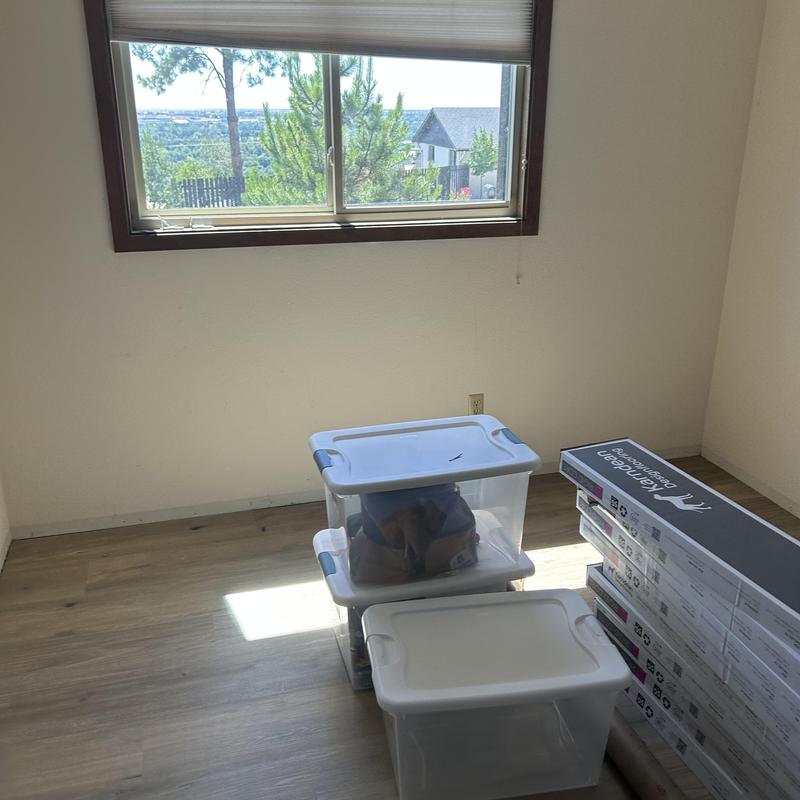 Vinyl plank flooring installation materials in empty room Vinyl plank flooring installation materials in empty room