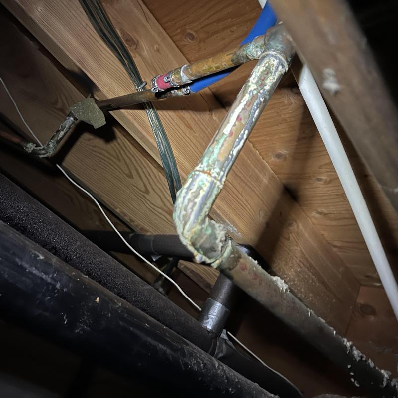 Corroded copper shower valve piping under floor joists Corroded copper shower valve piping under floor joists