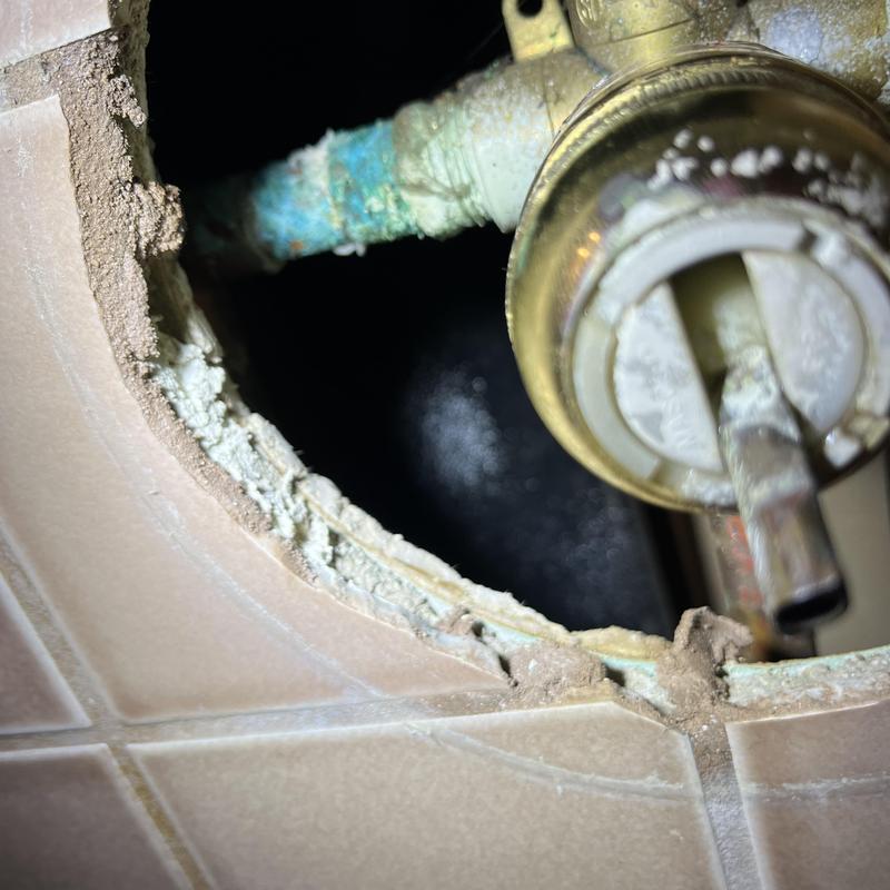 Shower valve with corroded copper piping behind tile wall Shower valve with corroded copper piping behind tile wall