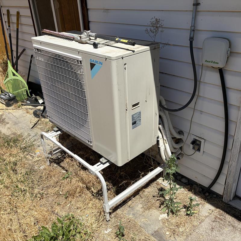 Mini-split outdoor condenser unit with tools on top Mini-split outdoor condenser unit with tools on top