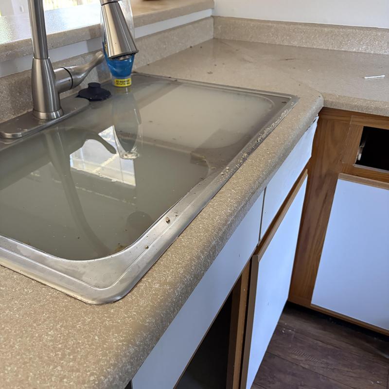 Kitchen sink filled with standing water and faucet Kitchen sink filled with standing water and faucet
