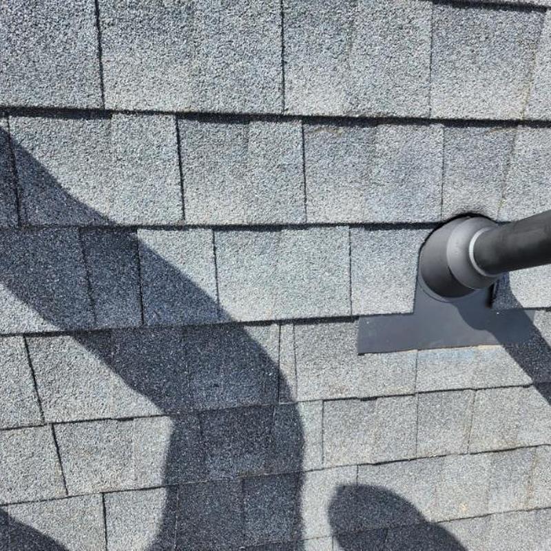 Vent pipe flashing on gray shingle roof in Sonora