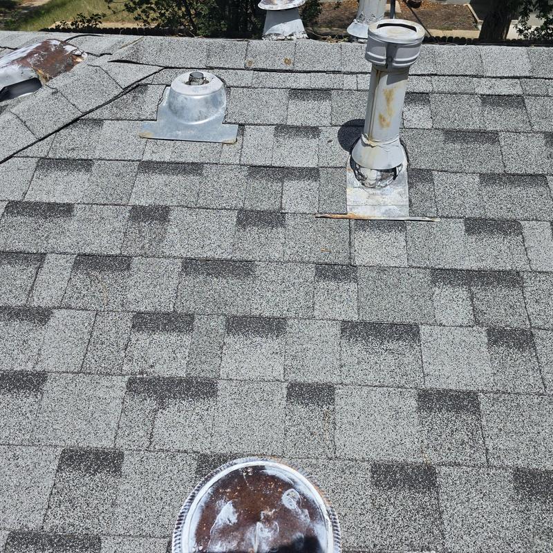 Asphalt shingle roof with vent pipe and flashing inspection