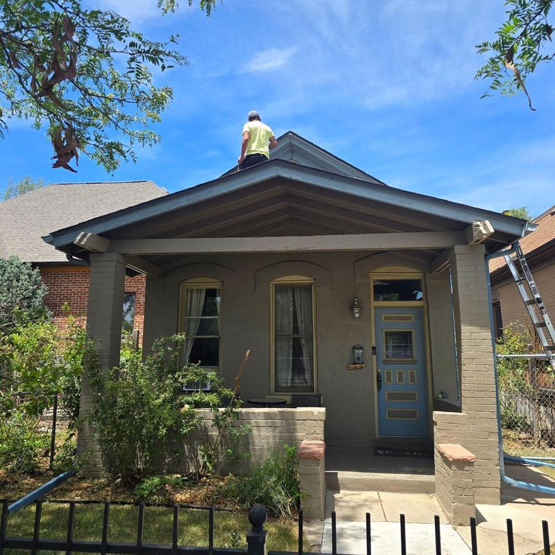 Shingle roof inspection with technician on roof