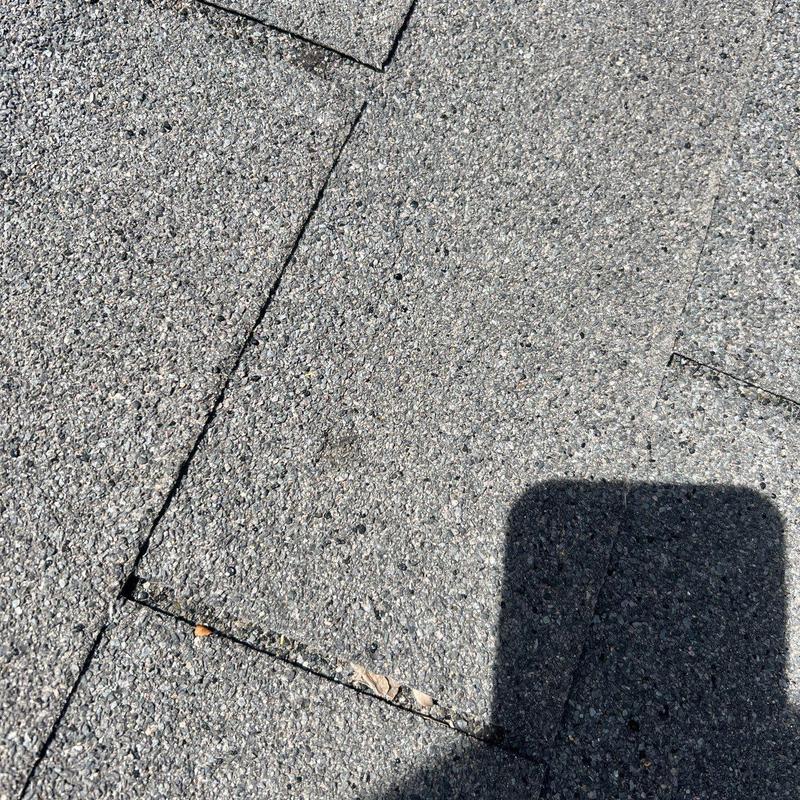 Asphalt shingle roof with minor hail damage close-up