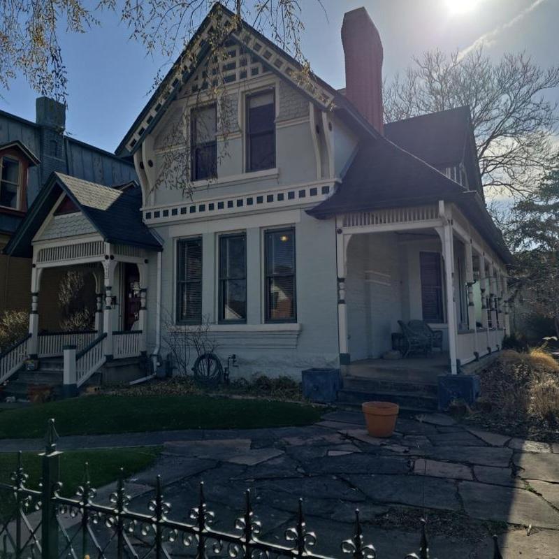 Shingle roof inspection on Victorian-style home