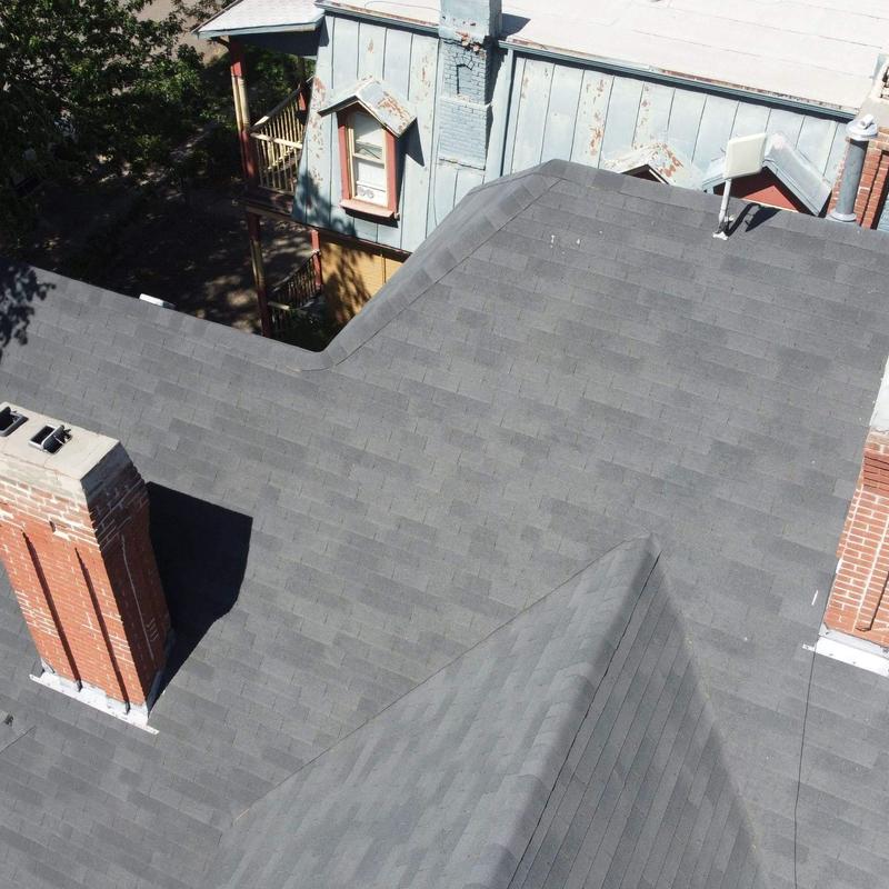Asphalt shingle roof with chimney and no visible damage