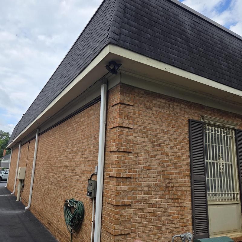 Mansard shingle roof and brick wall exterior inspection