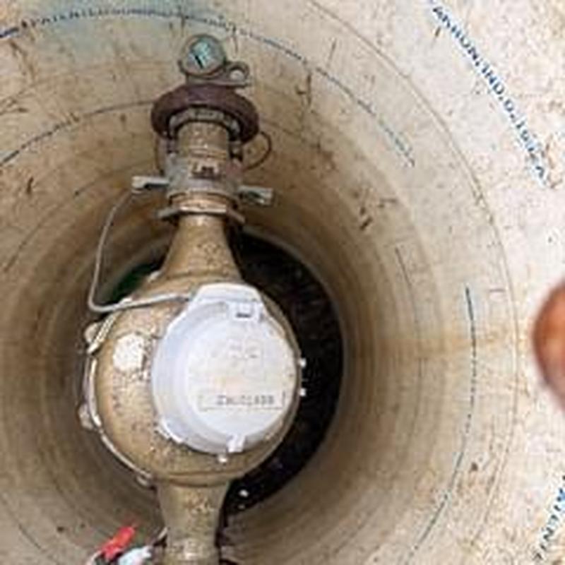 Water meter inside concrete meter pit inspection
