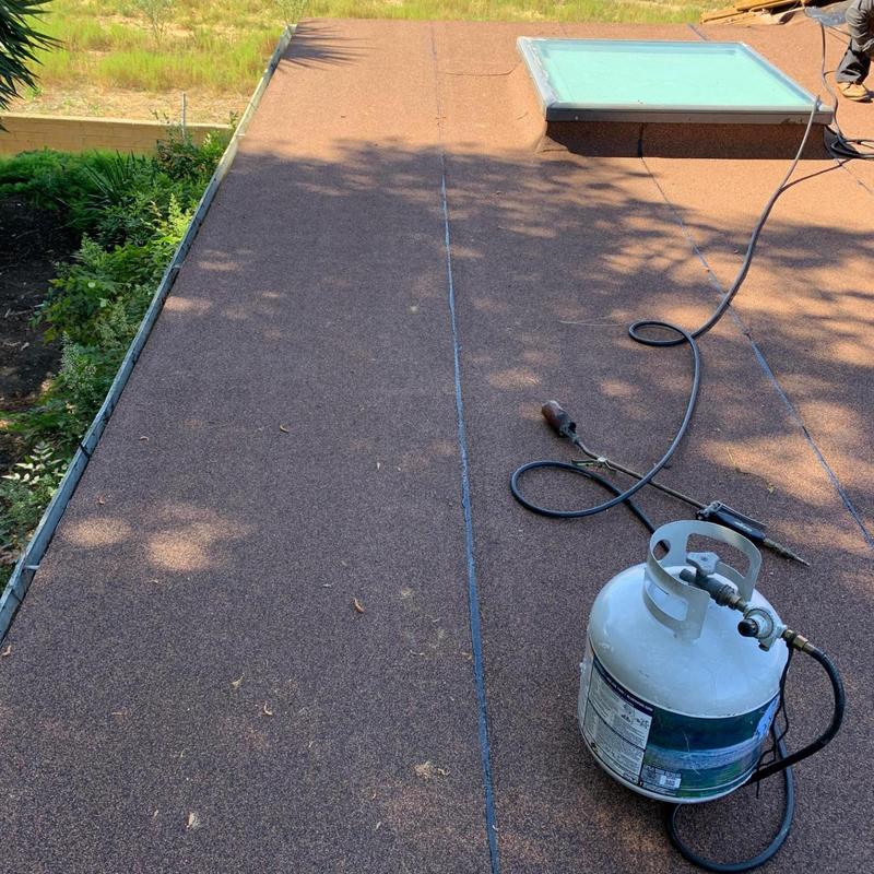 Torch down roofing system installation on flat roof Torch down roofing system installation on flat roof