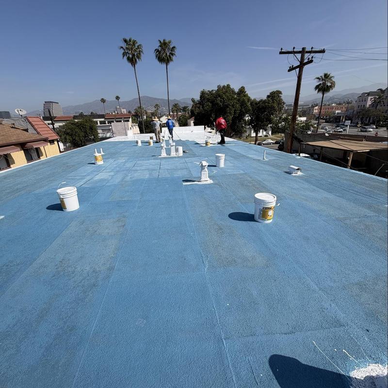 Silicone roof coating application with buckets Silicone roof coating application with buckets