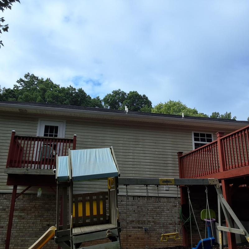 Roof shingles inspection on residential home in daylight