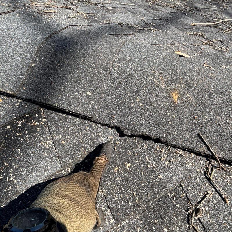Asphalt shingles with hail damage and cracks