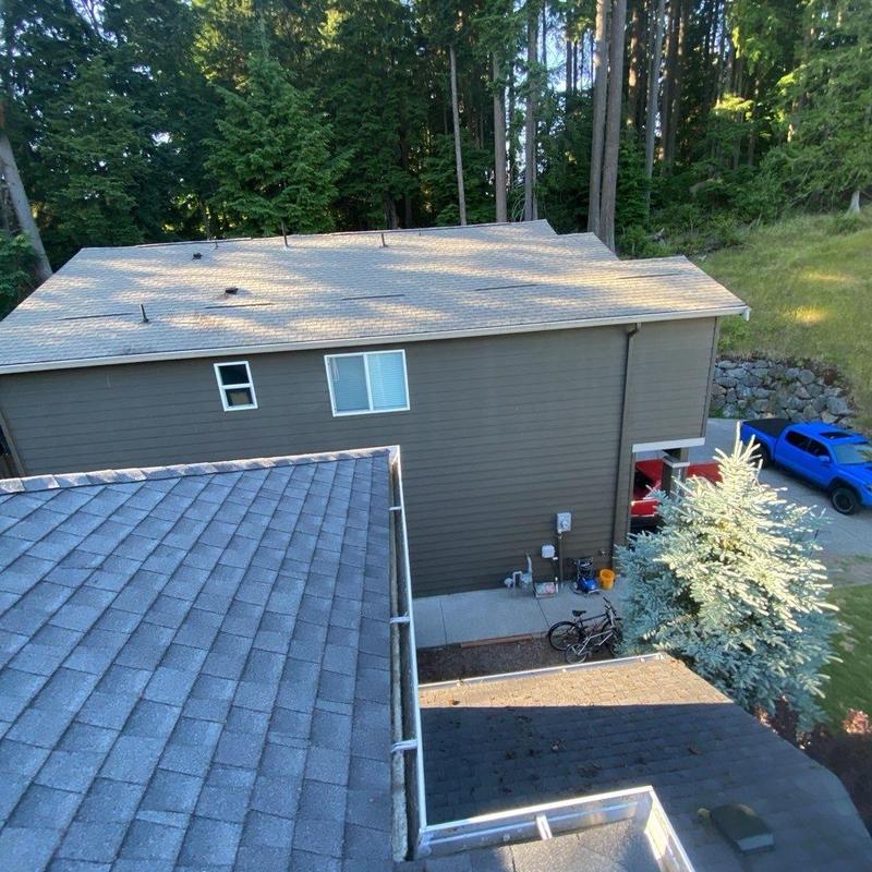 Roof shingles and gutters cleaned with moss treatment