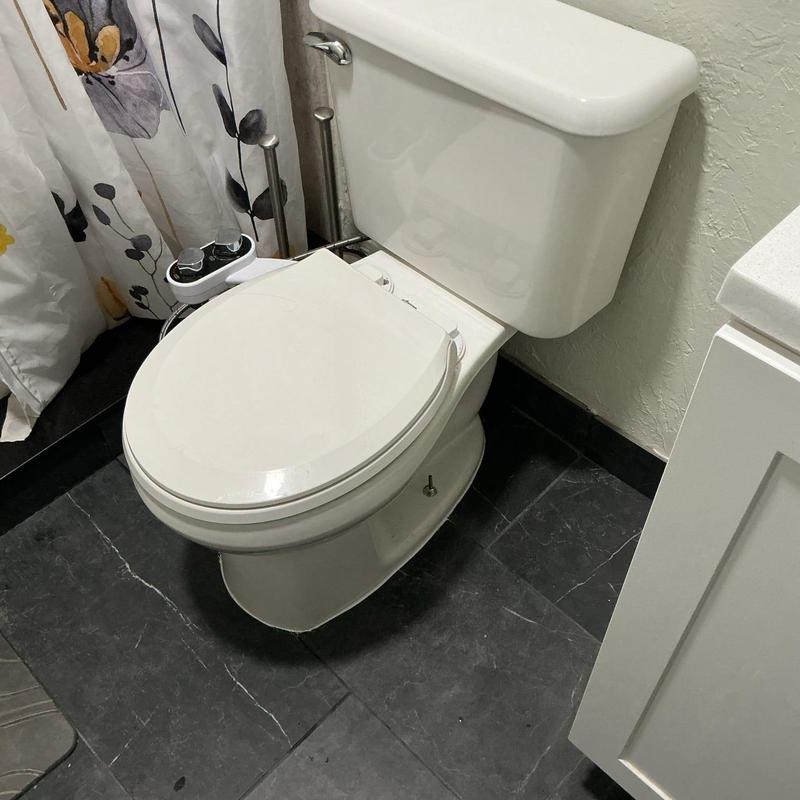 Toilet set with new wax ring and caulking in bathroom