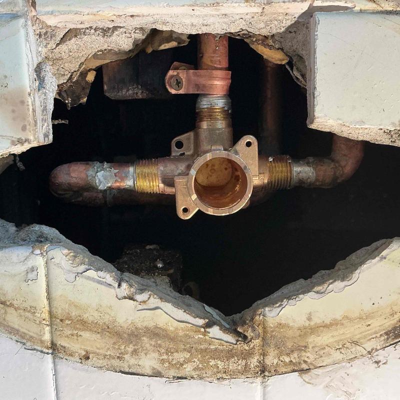Copper shower valve plumbing inside wall cavity