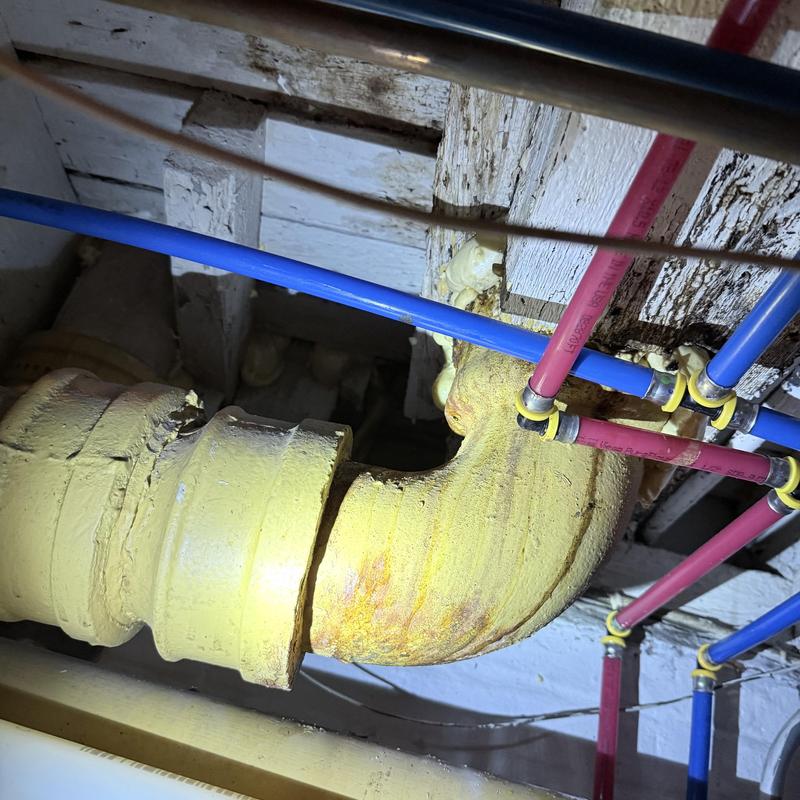 Toilet flange and piping under floor with water lines Toilet flange and piping under floor with water lines