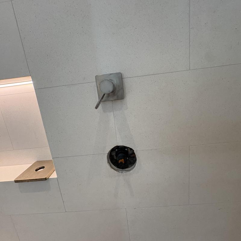 Shower valve installation with control handle in tile wall