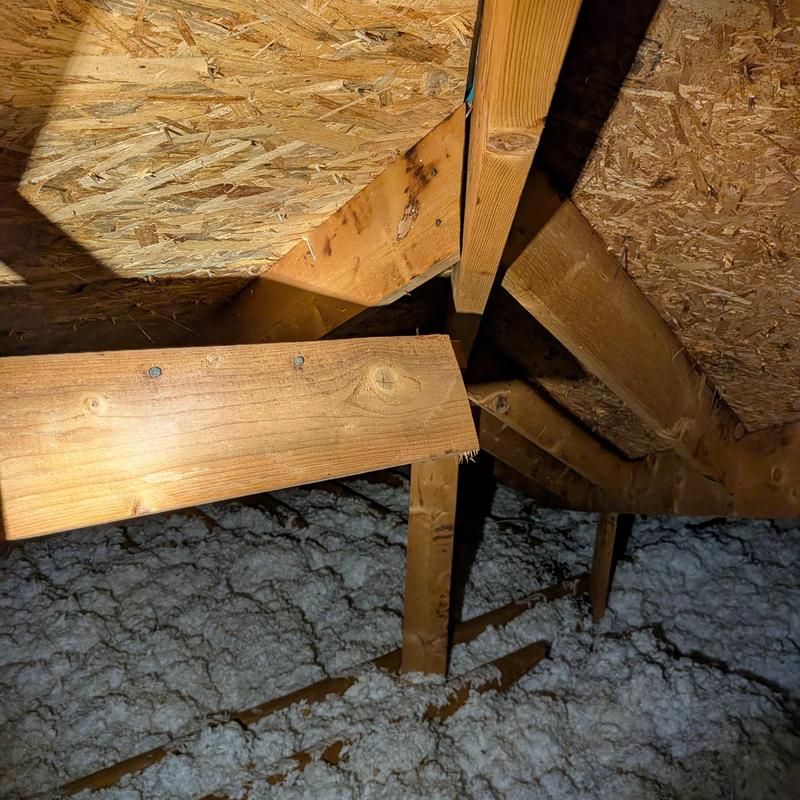 Attic wood framing with insulation and roof decking