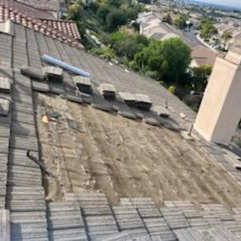 Tile roof section with removed tiles for repair
