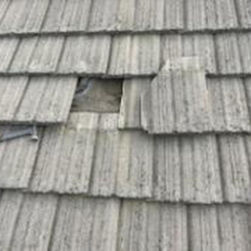 Tile roof with missing and damaged tiles