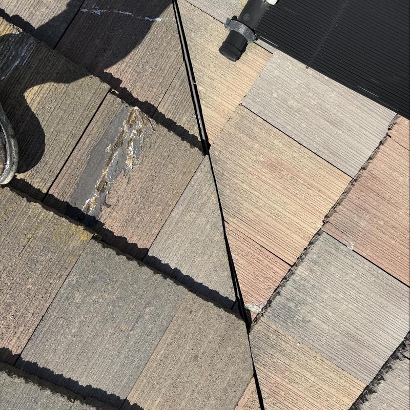 Tile roof with damaged and worn sections inspected