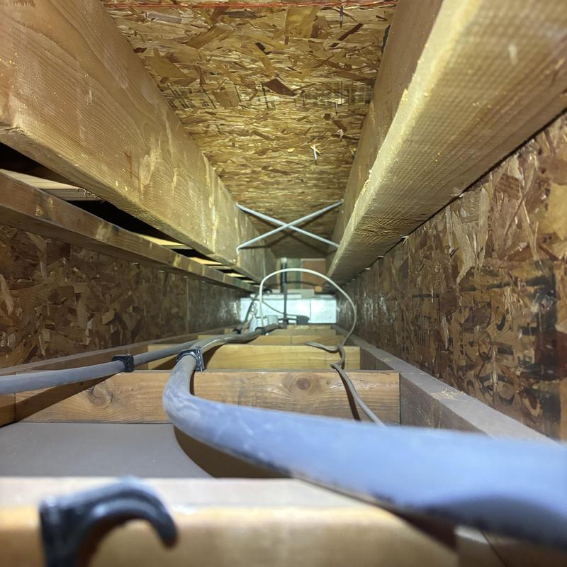 Drywall access hole cut above ceiling joists
