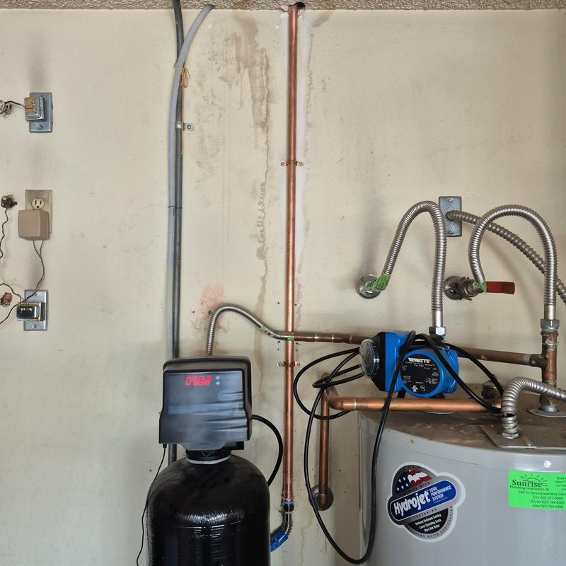 Water softener system with pump and piping