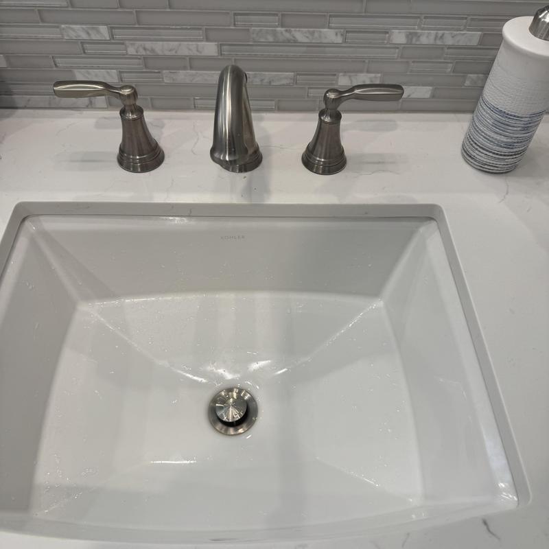 Delta bathroom faucet with metal handles on countertop