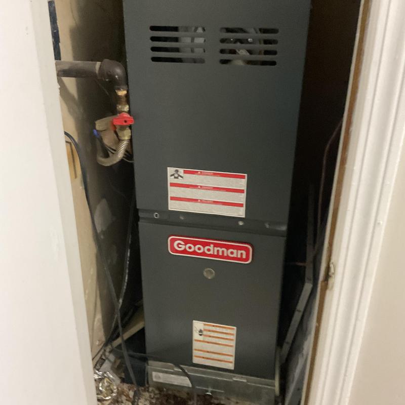 Furnace unit in utility closet with pipe connections