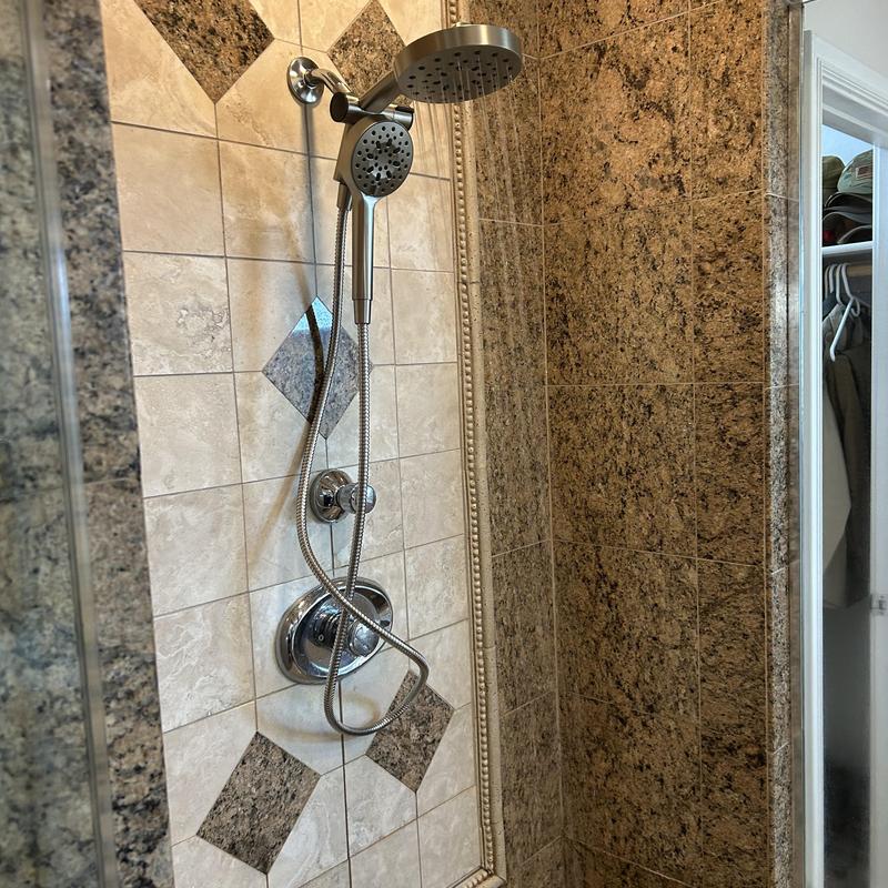 Kohler showerhead with handheld sprayer in tiled shower