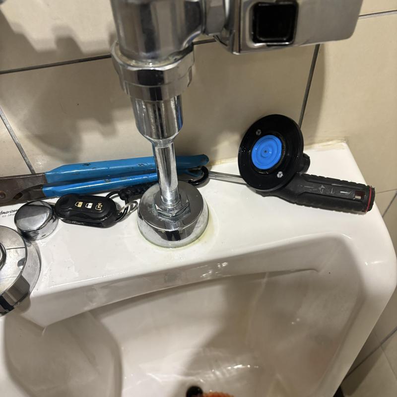 Sloan Royal valve installation with tools on urinal