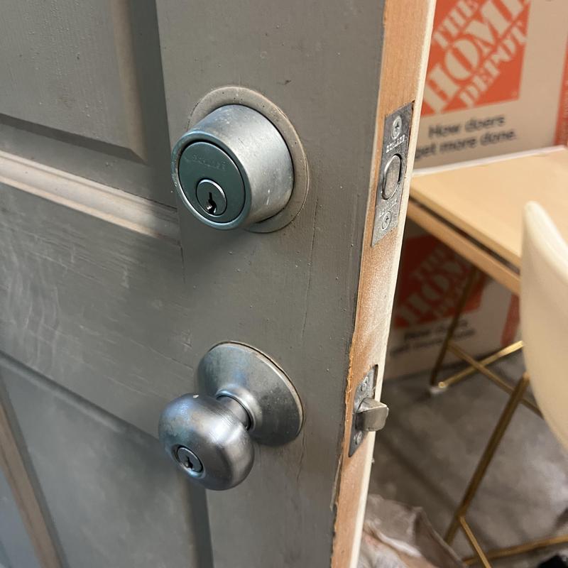 Door lock and deadbolt on gray exterior door
