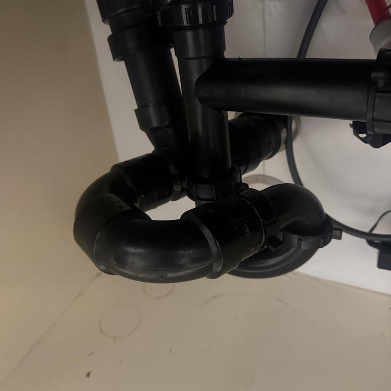 Garbage disposal drain pipes and fittings under sink
