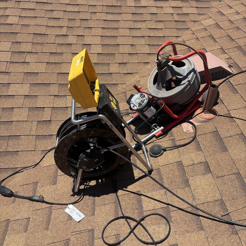 Sewer line camera and root cutter on roof vent