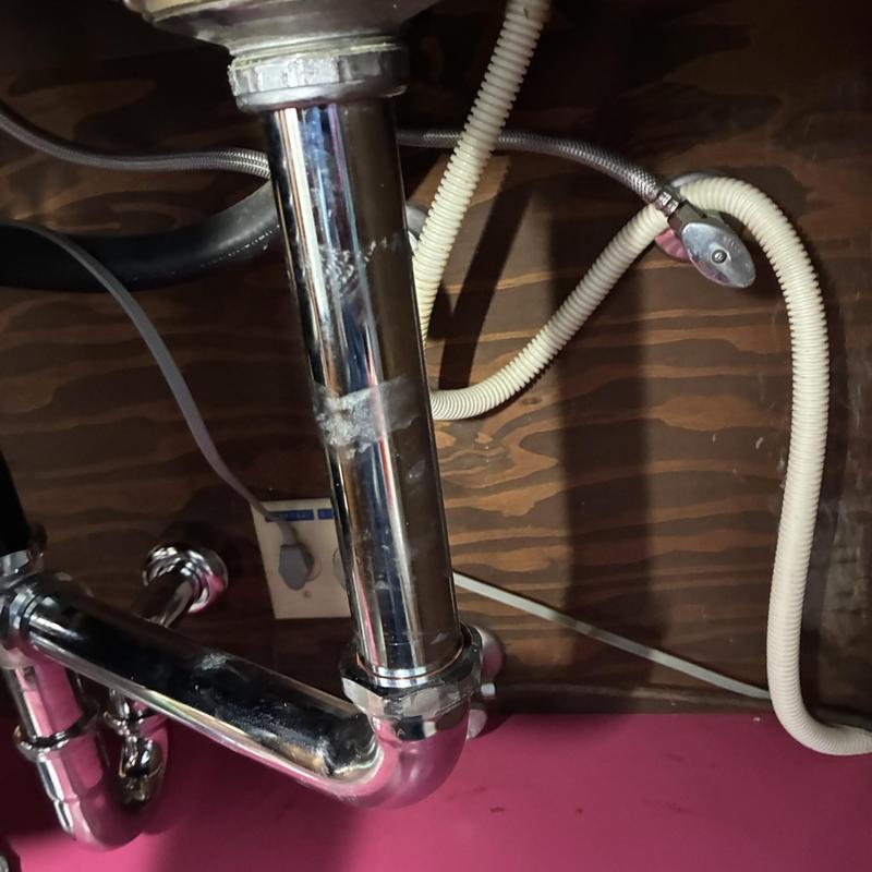 P-trap and drain pipes under kitchen sink